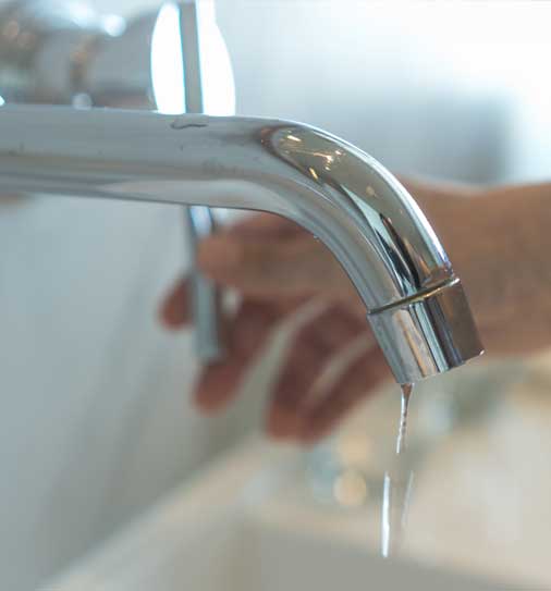 Person turning tap water on